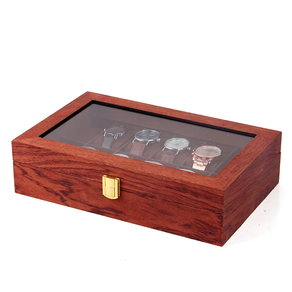 Wooden watch display case with glass top showing organized timepiece collection